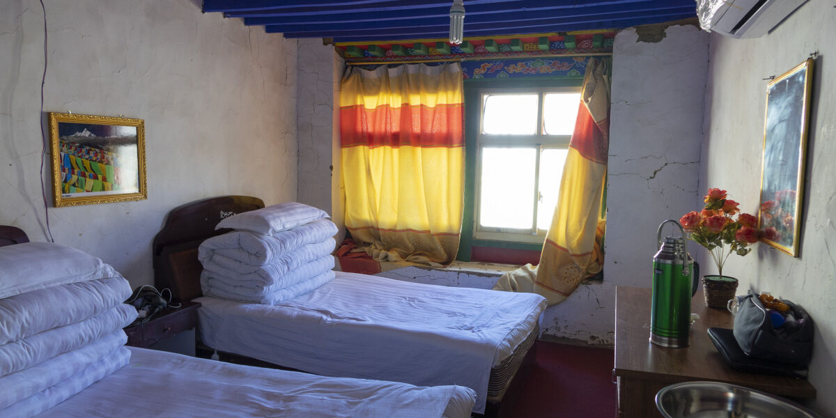 A little whitewashed room with brightly coloured curtains