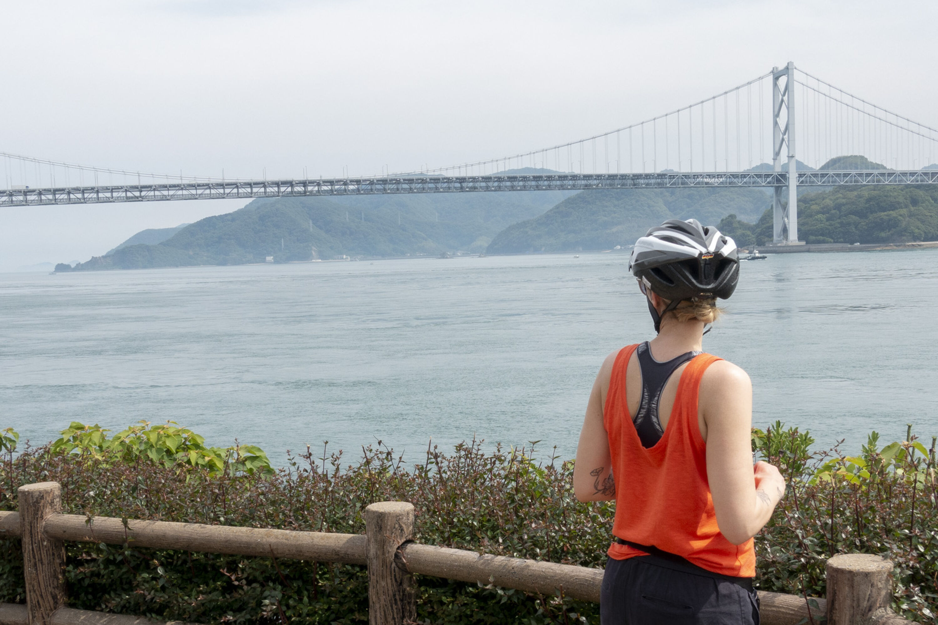 cycling holiday in japan woman looking out at bridge