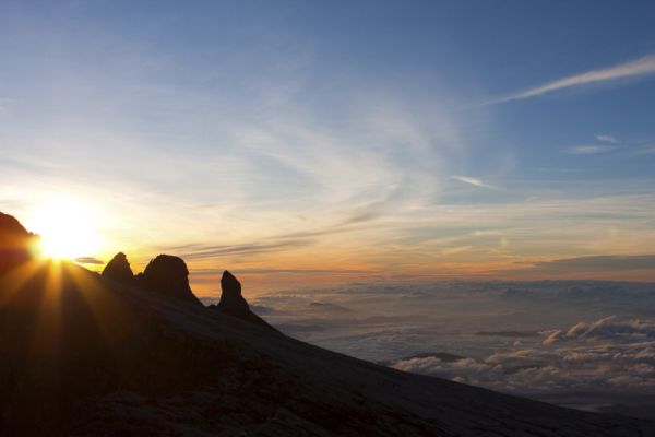 Sun rising behind a mountain peak in Borneo