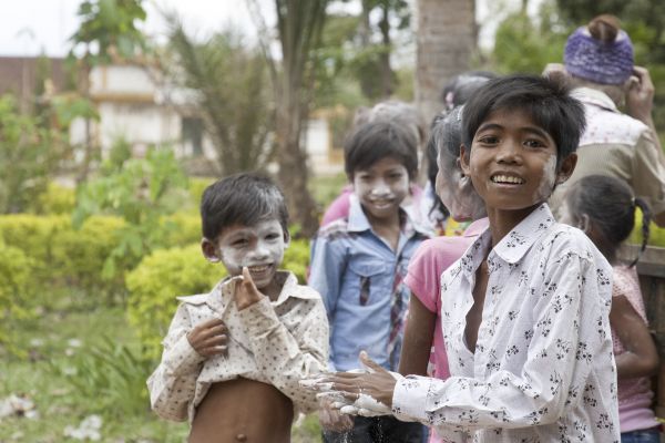 Small boys in Cambodia, their smiling faces daubed with white chalk