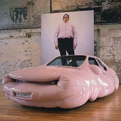 Art installation: a car made of bulging pink plastic